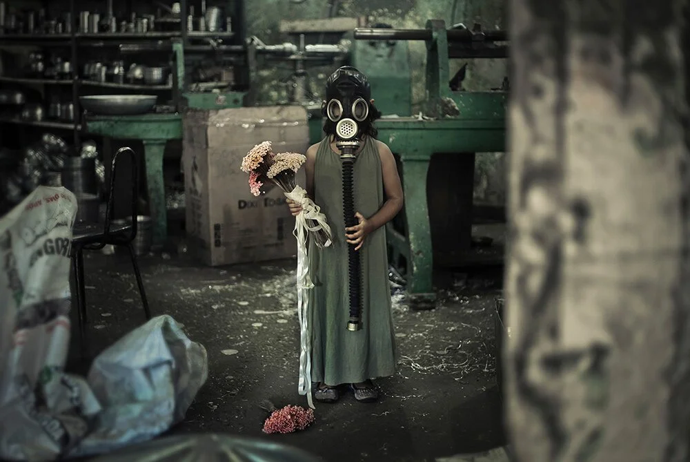 Girl with a gas mask holding flowers — photography by Luiza Prado